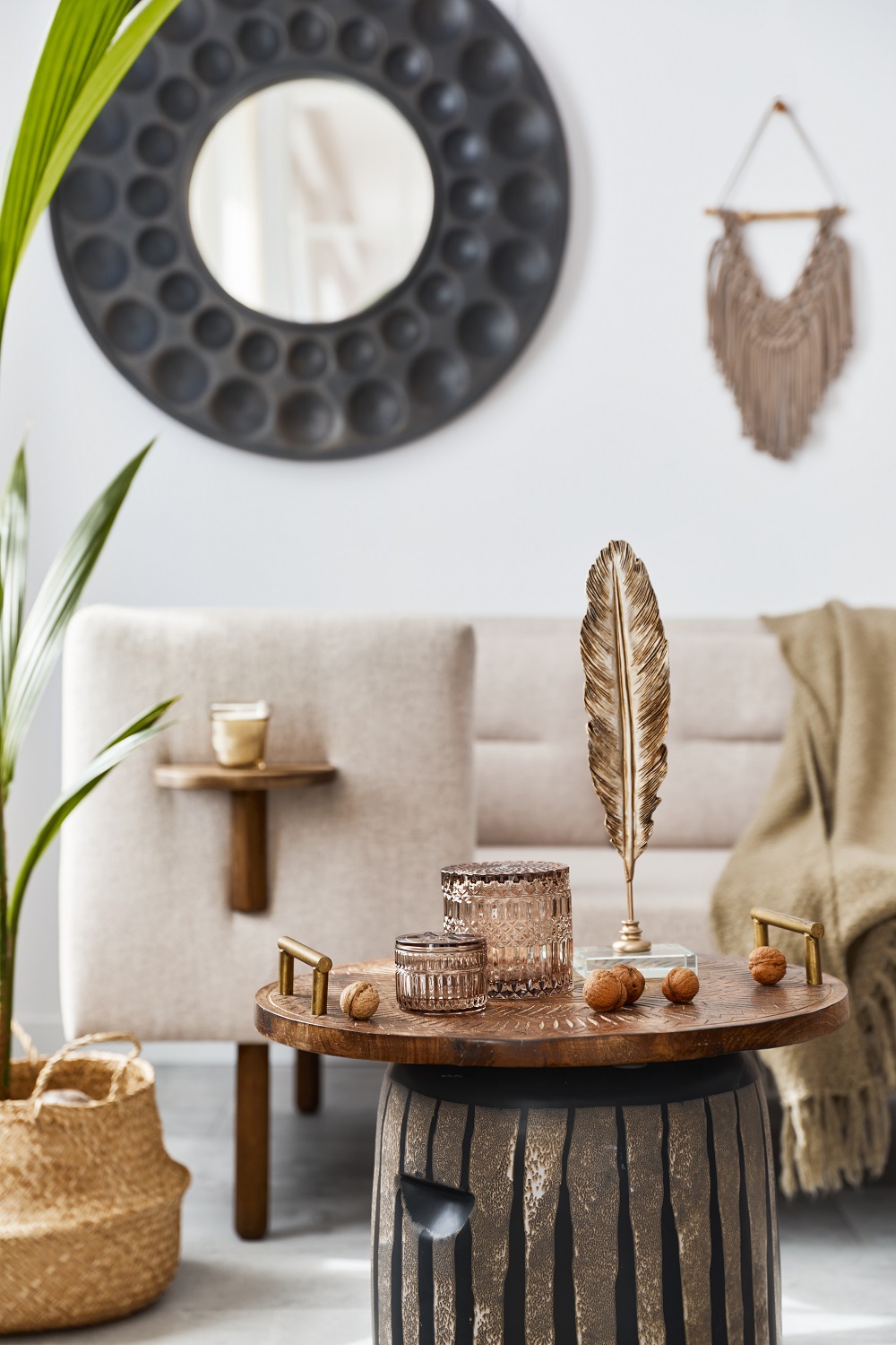 Elegant ethnic composition of stylish living room interior with design coffee table, sofa, decoration and acceessories in cozy home decor. Template. Details.